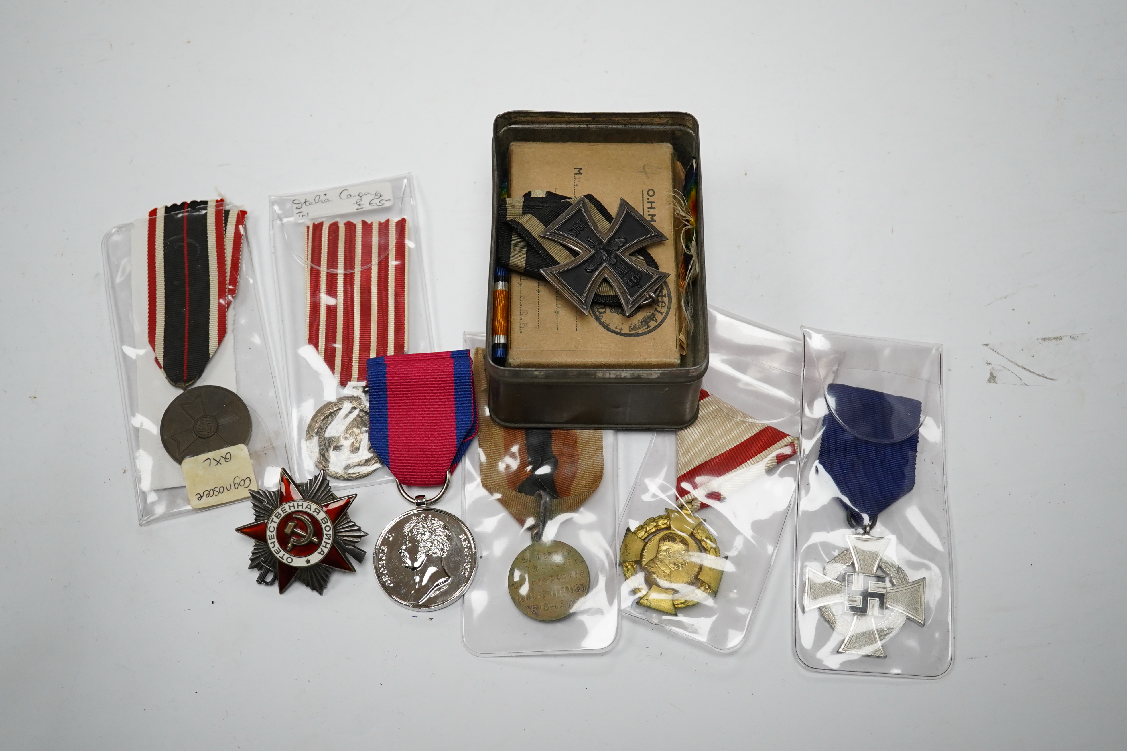 Fifteen British, German, etc. military medals including; a First World War medal pair to DVR. A.E. Hooker. R.A., a boxed WWII Defence Medal, a 1914 Second Class Iron Cross, a France Italian Campaign medal, a 1939 German